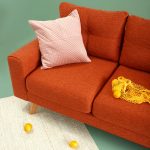 maximalist living room sofa in bold orange with pink throw pillow